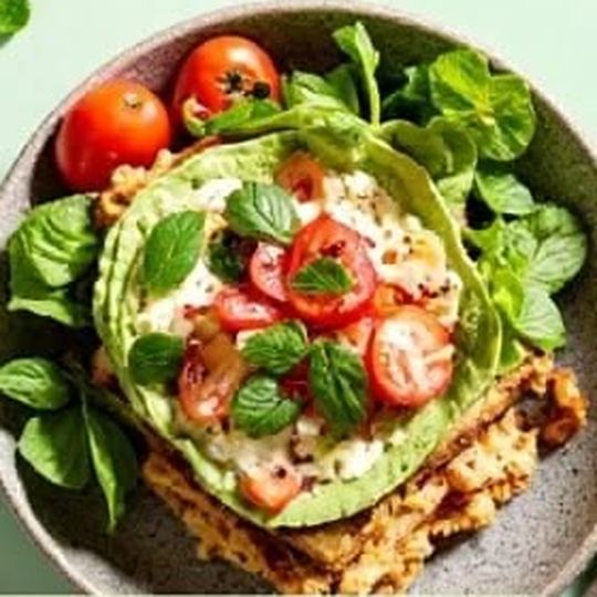 Smashed avocado toast with blistered tomatoes and basil